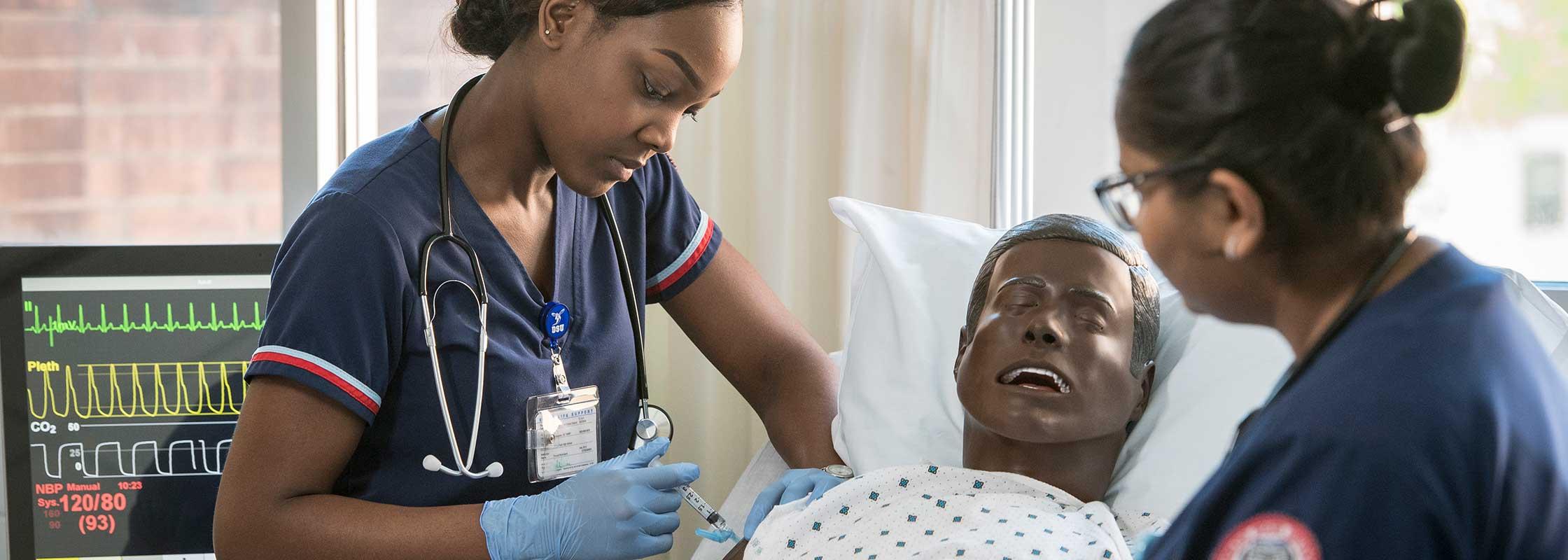 2 nursing students administering a shot